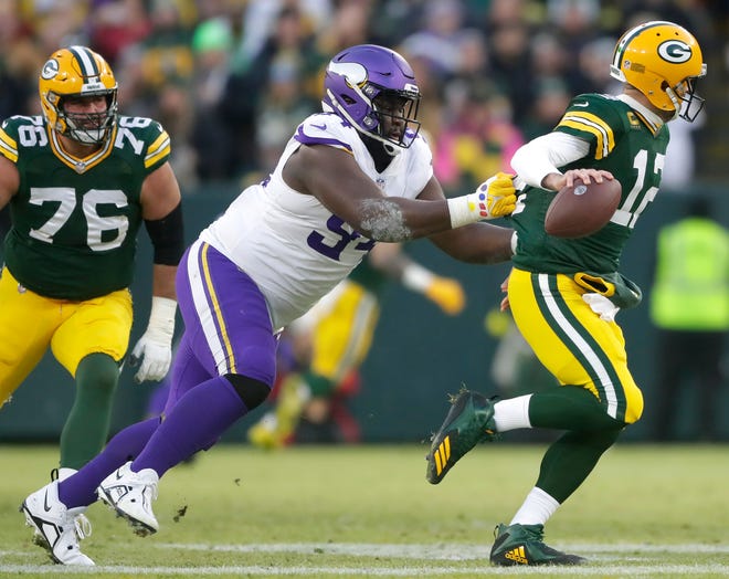 Minnesota Vikings defensive tackle Dalvin Tomlinson (94) pressures Green Bay Packers quarterback Aaron Rodgers (12) causing a fumble during their football game on Sunday, January, 1, 2023 at Lambeau Field in Green Bay, Wis. 
Wm. Glasheen USA TODAY NETWORK-Wisconsin