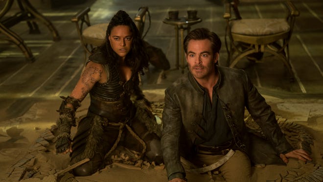 Lute-playing Edgin (Chris Pine) teams with barbarian Holga (Michelle Rodriguez) on an epic quest in "Dungeons & Dragons: Honor Among Thieves," based on the popular role-playing fantasy game.
