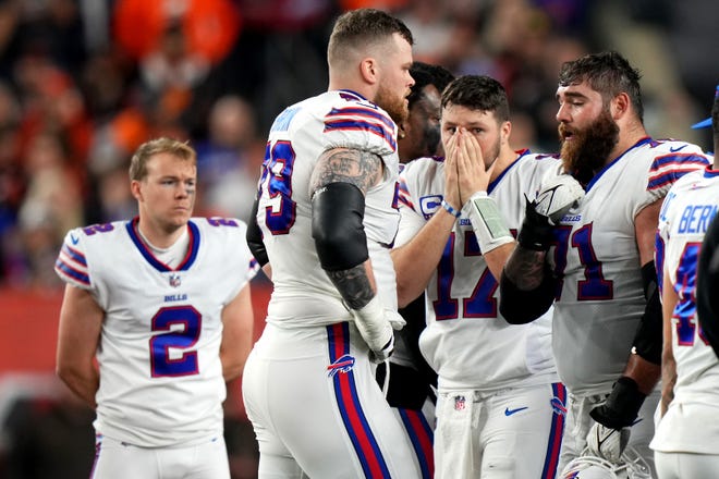 Buffalo Bills quarterback Josh Allen (17) and the Buffalo Bills react as Buffalo Bills safety Damar Hamlin (3) is tended to on the field after a collision in the first quarter of a Week 17 NFL game against the Cincinnati Bengals, Monday, Jan. 2, 2023, at Paycor Stadium in Cincinnati.