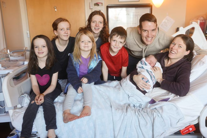 Natalie Hope Bean, the first baby born in 2023 at Salem Health Family Birth Center, is surrounded by her parents, Scott and Anne Bean, and her five siblings.