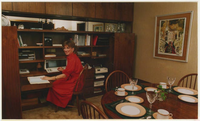 Nancy Brown at her cabinets with her computer