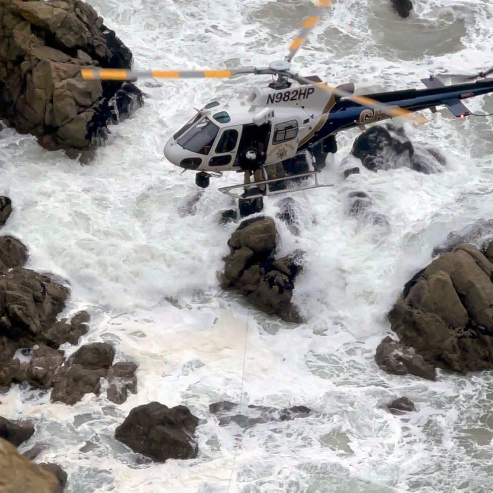 This image from video provided by San Mateo County Sheriff's Office shows a helicopter rescue after a Tesla plunged off a Northern California cliff along the Pacific Coast Highway, Monday, Jan. 2, 2023, near an area known as Devil's Slide, leaving four people in critical condition, a fire official said.