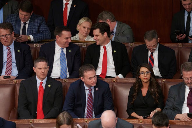 Rep. Matt Gaetz, R-Fla. (center middle row) takes a seat after he nominates Rep. Jim Jordan (R-OH) as House speaker prior to a second round of voting.