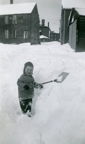 Sherman "Sherm" Pridham poses with a shovel during a 1945 snowstorm in Puddle Dock, now part of Strawbery Banke Museum in Portsmouth. Though his home survived, most of the neighborhood's buildings were taken by eminent domain and torn down during one of the city's urban renewal projects in the 1960s.