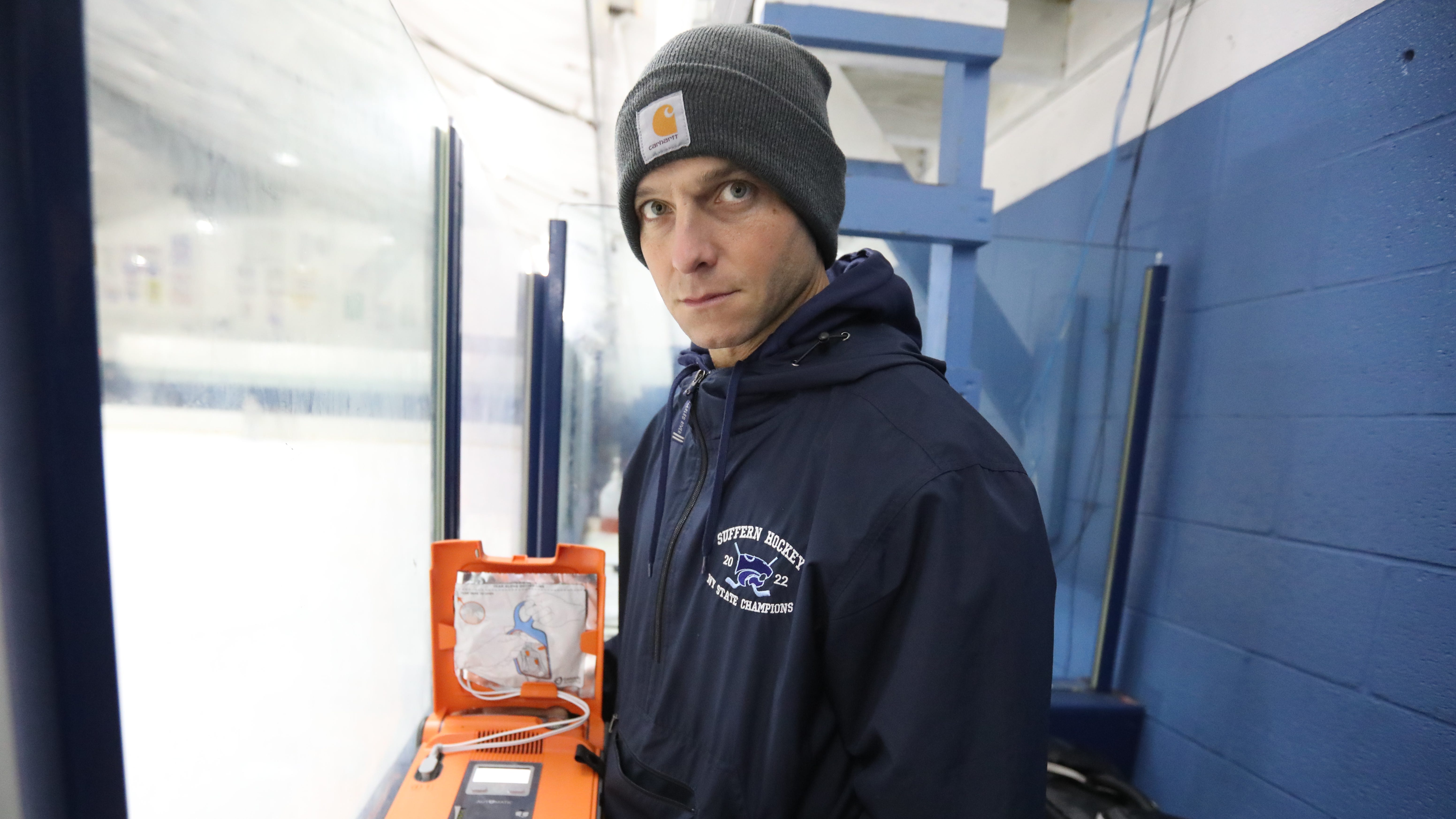 Sufgfern High School athletic trainer Rob Addon shows the defibrillator he keeps with him in the penalty box during a hockey game at Sport-O-Rama in Monsey Jan. 3, 2023.