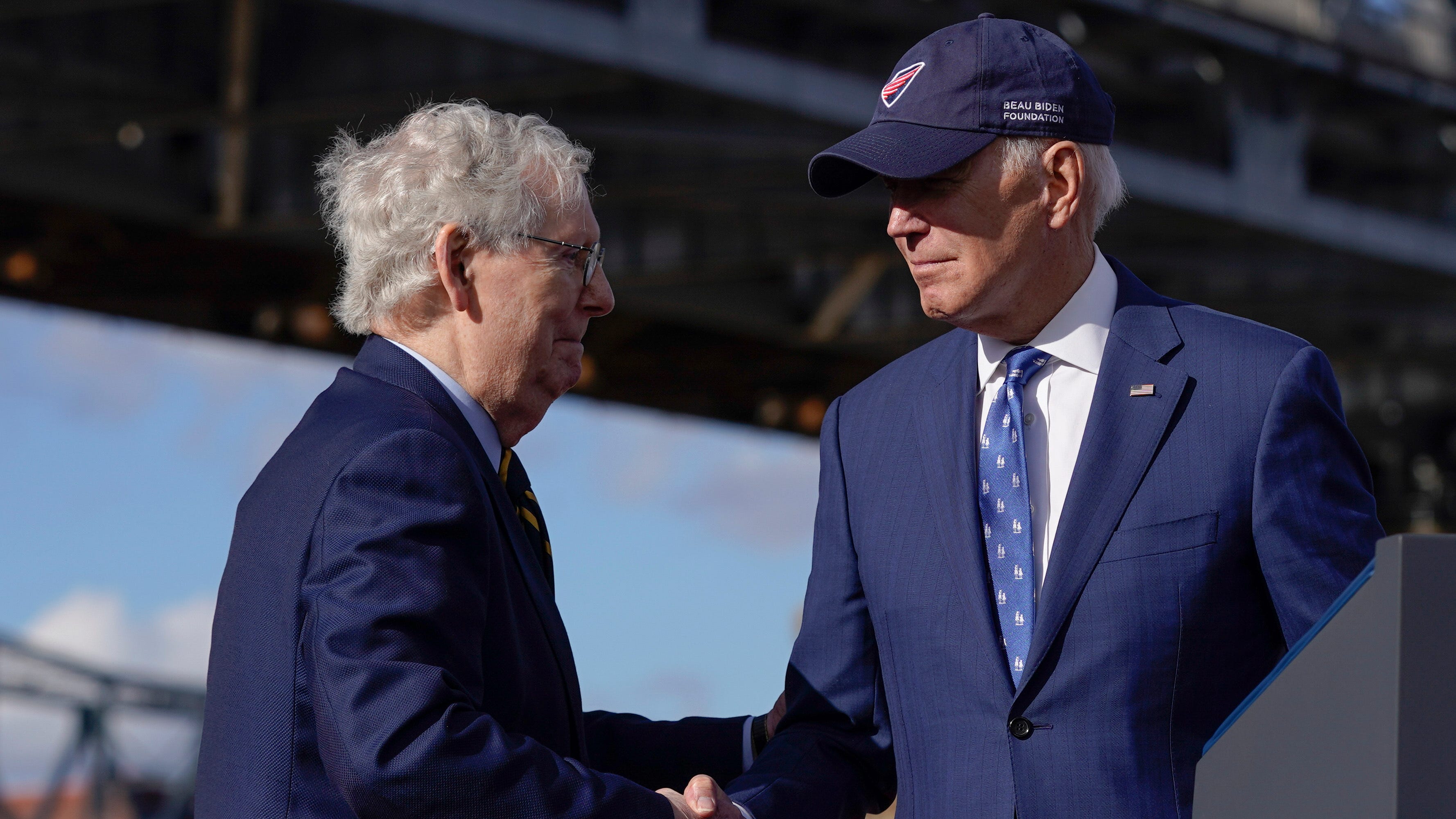 President Joe Biden shakes hands with Senate Minority Leader Mitch McConnell of Ky., after speaking about his infrastructure agenda under the Clay Wade Bailey Bridge, Wednesday, Jan. 4, 2023, in Covington, Ky. Biden's infrastructure deal that was enacted in late 2021 will offer federal grants to Ohio and Kentucky to build a companion bridge that is intended to alleviate traffic on the Brent Spence Bridge, background at left. (AP Photo/Patrick Semansky) ORG XMIT: KYPS443