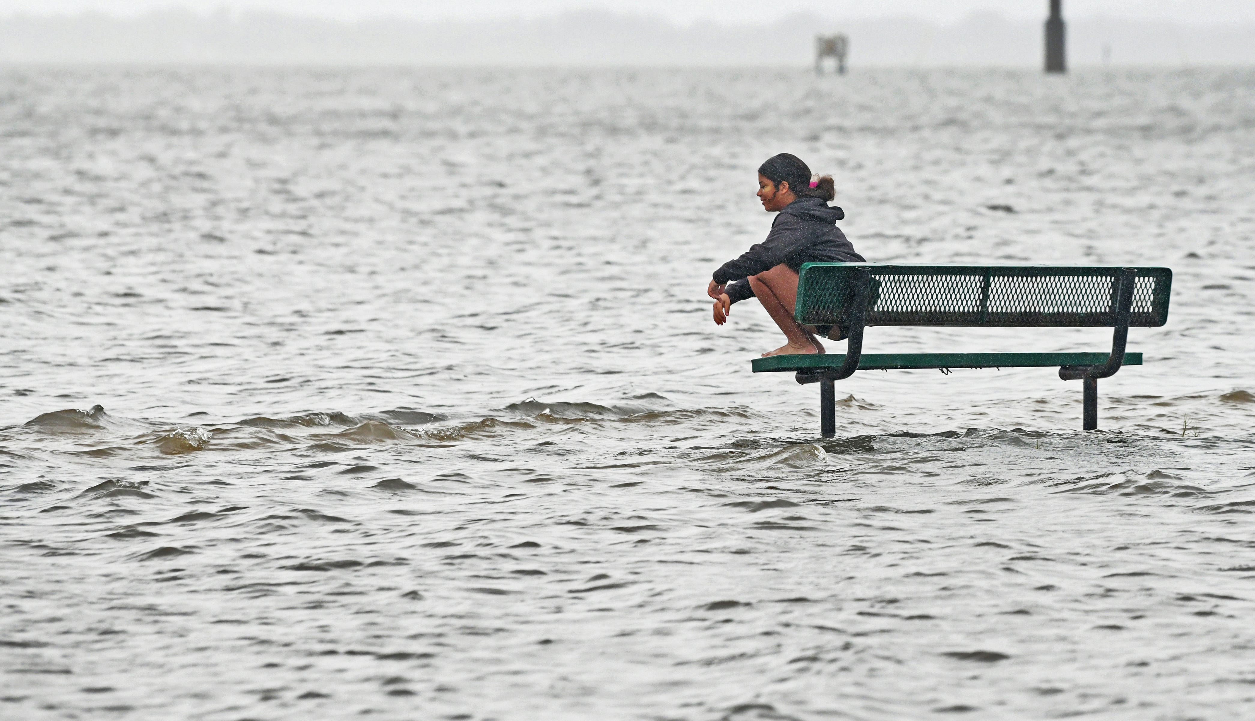 Trinity Moore humorously sits at a park bench at the Port St. John Boat Ramp on Thursday morning after the the winds of Ian had passed. Brevard County after being hit by rain and wind from Hurricane Ian on September 29, 2022.