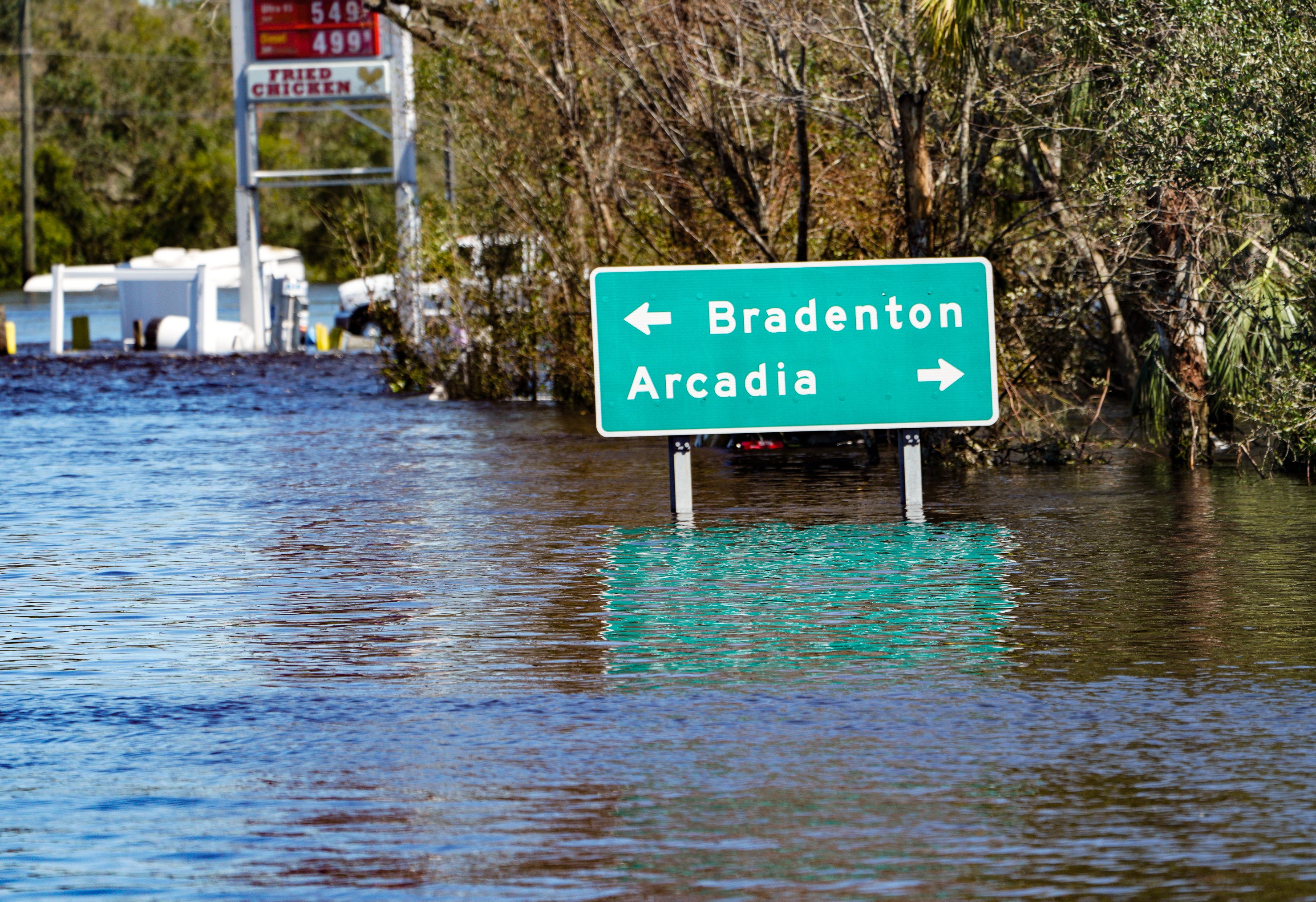 Road signs stick out of the water in a flooded area of DeSoto County, Florida, on Sunday, Oct. 2, 2022, following the passage of Hurricane Ian.