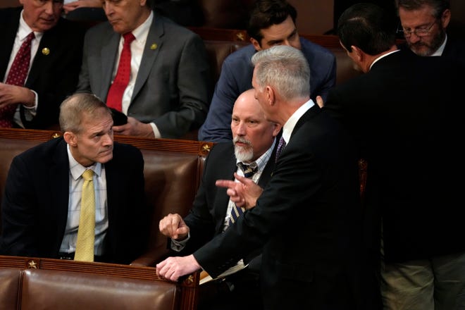 House Republican Leader Kevin McCarthy (R-CA) (R) talks to Rep.-elect Chip Roy (R-TX) (C) and Rep.-elect Jim Jordan (R-OH) in the House Chamber.