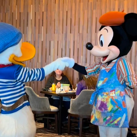 Donald Duck and Mickey Mouse shake hands at Topoli