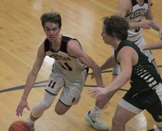 Cheboygan junior guard Brennen Thater (left) looks to get past Grayling's Kaleb Hall during the first half of Wednesday night's varsity boys basketball clash in Cheboygan.