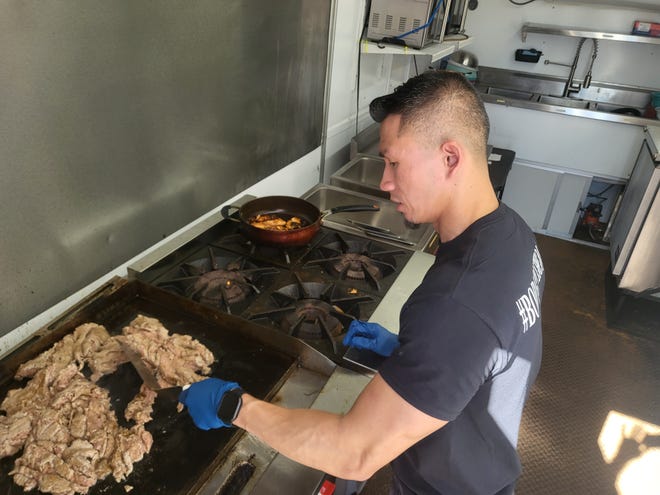 Thomas Nguyen cooks his signature dish, the eggroll bowl in his food truck, which sits behind his newly opened restaurant in Houma.
