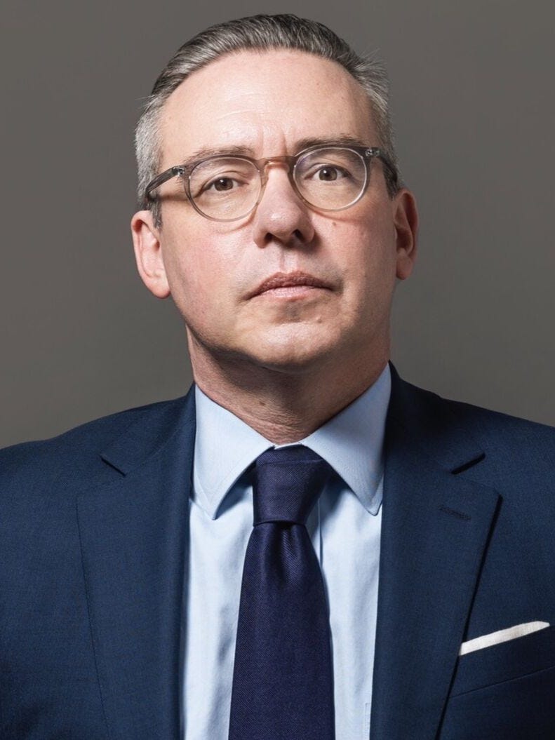 Al Schmidt wearing glasses, suit and tie.