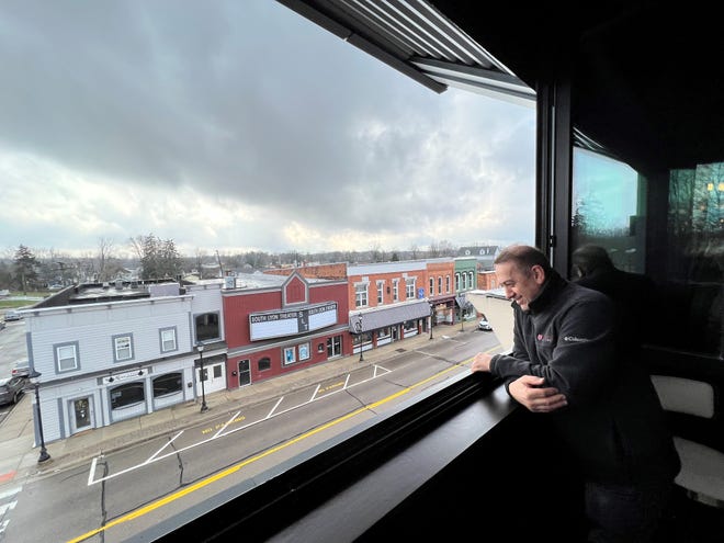 Tom Palushaj, owner of Dua Vino, looks out the open air window of the new bar and restaurant, down onto E. Lake Street in South Lyon.