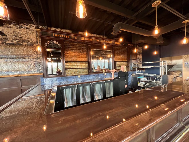 Cheryl Frasier shows the upstairs bar at Dua Vino, Jan. 4, 2023. The South Lyon restaurant, formerly the RCA building, plans to welcome guests in late February.