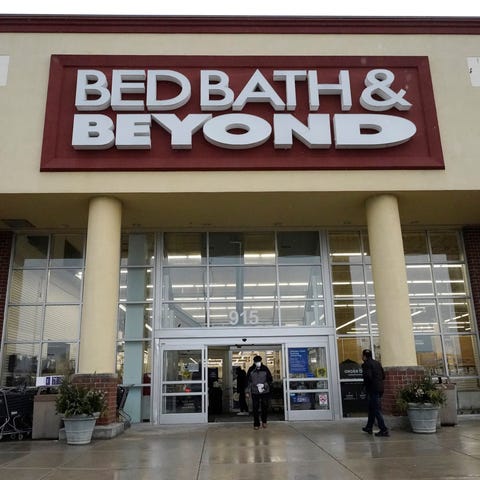 FILE - Shoppers enter and exit a Bed Bath & Beyond