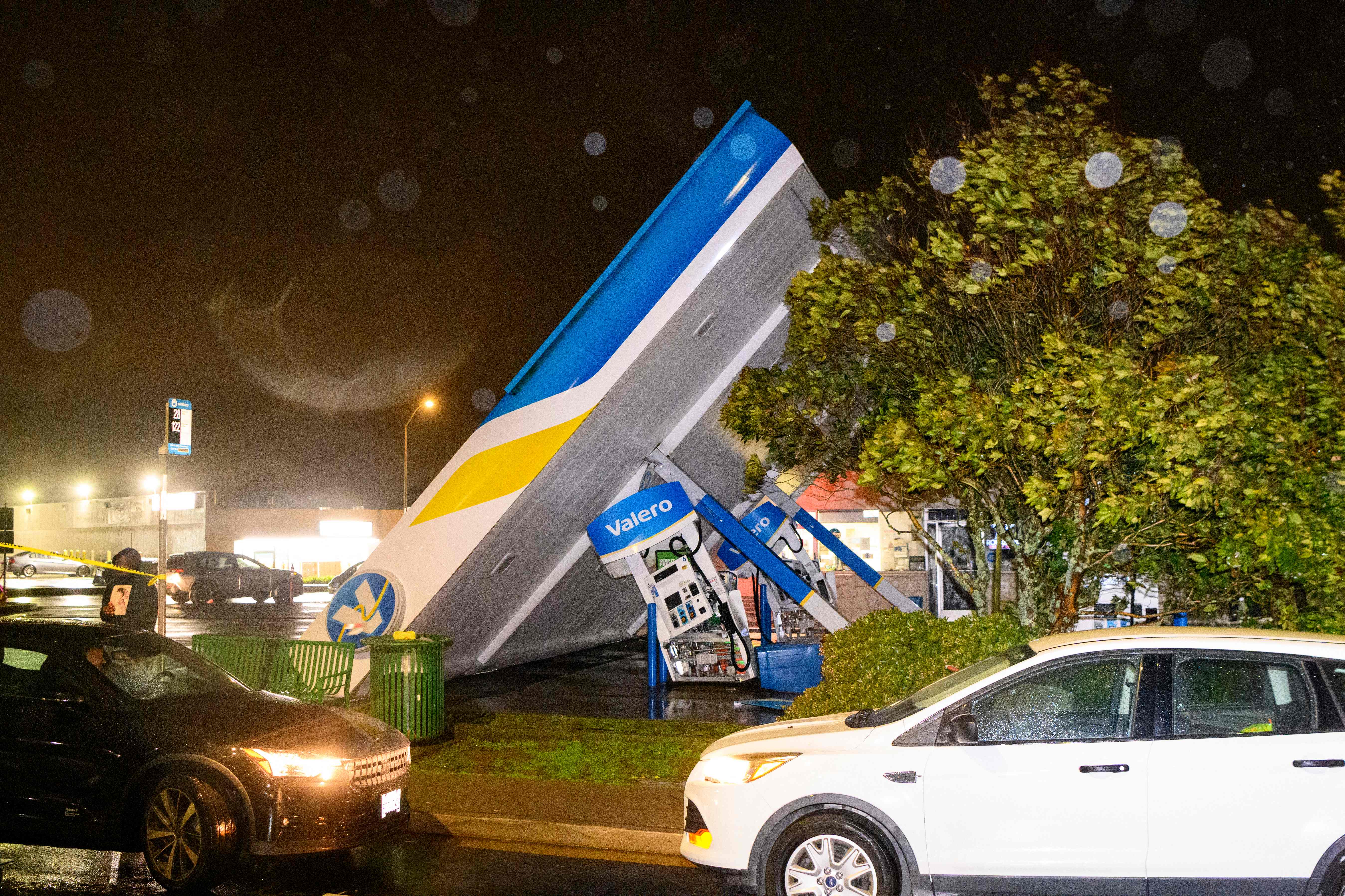 A damaged Valero gas station creaks in the wind during a massive "bomb cyclone" rainstorm in South San Francisco on Wednesday.