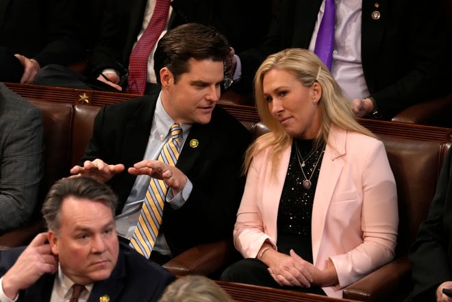 Rep. Matt Gaetz, R-Fla., left, talks with Rep. Marjorie Taylor Greene, R-Ga., in the House chamber on Thursday, Jan. 5, 2023.