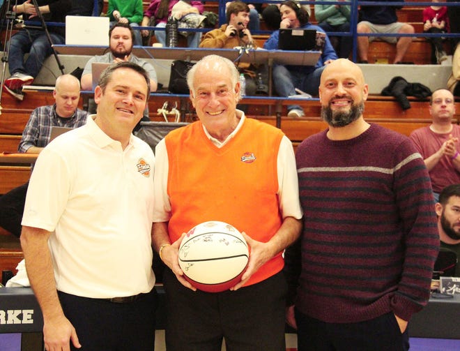 Jim Drengwitz, center, receives a ceremonial basketball before the tip off of the Pontiac-Aurora West basketball on the first night of the Pontiac Holiday Tournament. Drengwitz retired from his role as tournament director after 29 years at the helm. With Drengwitz are Pontiac head coach Matt Kelley, left, and Aurora West head coach Brian Johnson.