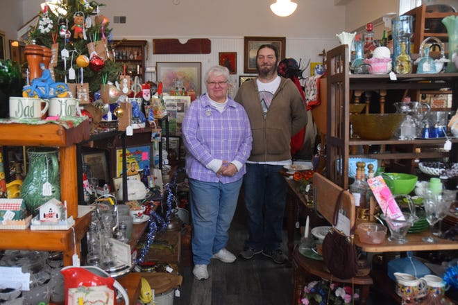 Pam Ignatowski (left) and her son Derek (right) stand in their vintage store, Happymess at 6241 River St. in Alanson on Thursday, Jan. 5.