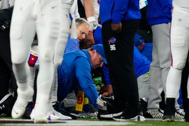 Team medical staff perform life savings efforts on Buffalo Bills safety Damar Hamlin (3) after he collapsed on the field following a tackle in the first quarter of the NFL Week 17 game between the Cincinnati Bengals and the Buffalo Bills at Paycor Stadium in Downtown Cincinnati on Monday, Jan. 2, 2023. The game was suspended with suspended in the first quarter after Buffalo Bills safety Damar Hamlin (3) was taken away in an ambulance following a play. 