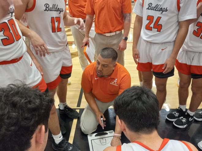 Artesia High School basketball coach Michael Mondragon discusses strategy during a timeout. Artesia defeated Las Cruces High School Jan. 5, 2023, in the North-South Shootout.