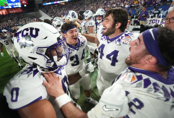 TCU players celebrate their 51-45 win over Michigan at the Fiesta Bowl on Dec. 31. The Horned Frogs, who were picked to finish seventh in the Big 12 in July, face defending national champion Georgia in Monday night's CFP championship game.