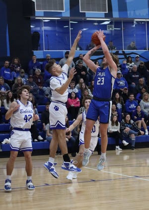 Buckeye Trail's Garrett Burga gets off a shot over Cambridge's Davion Bahr during Friday's non-league battle between the neighboring schools. Burga tallied a game high 20 points to lead Trail to a hard fought 51-46 win. Bahr paced the Bobcats with 16 points.