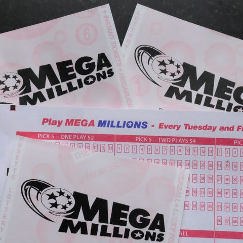 Mega Millions lottery tickets and a wager slip are