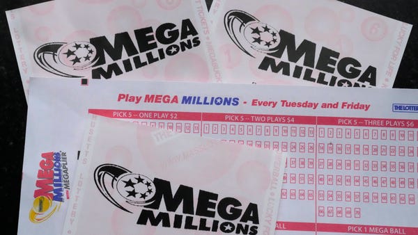 Mega Millions lottery tickets and a wager slip are