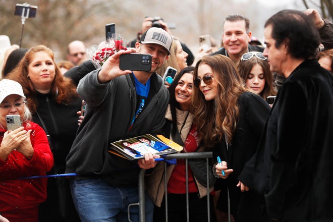 Lisa Marie Presley poses for a photo with fans gathered on the front lawn of Graceland to celebrate Elvis' birthday on January 8, 2023 in Memphis.