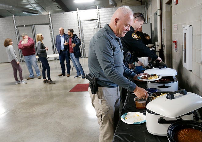 Ashland County sheriff's Chief Deputy Dave Blake goes through the line to get his food at a barbecue provided by the Ashland County Prosecutor's Office on Law Enforcement Appreciation Day Monday.
