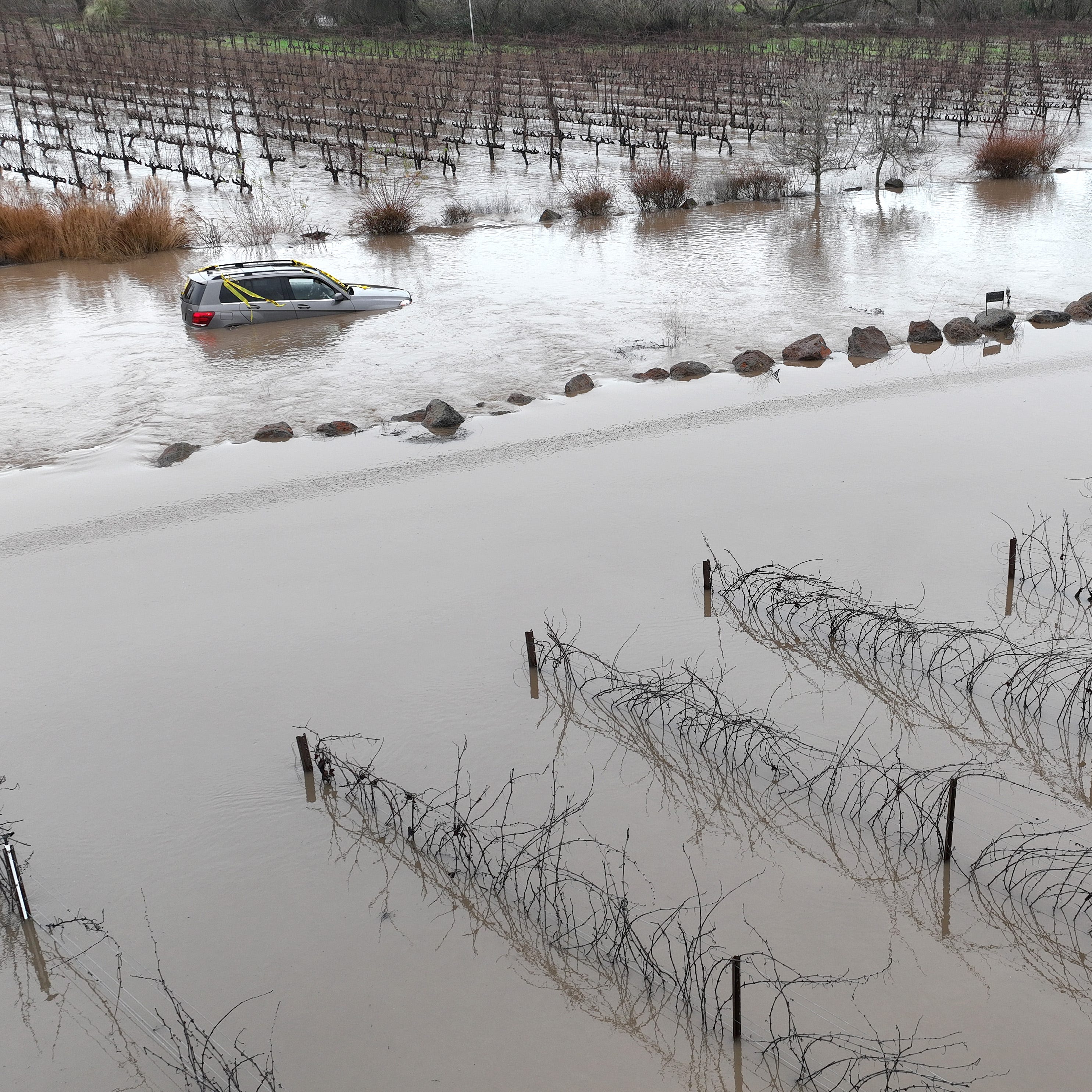 In an aerial view, cars are submerged in floodwater after heavy rain moved through the area on January 9, 2023 in Windsor, California. Storms are lined up over the Pacific Ocean and are expected to bring more rain and wind through the end of the week.