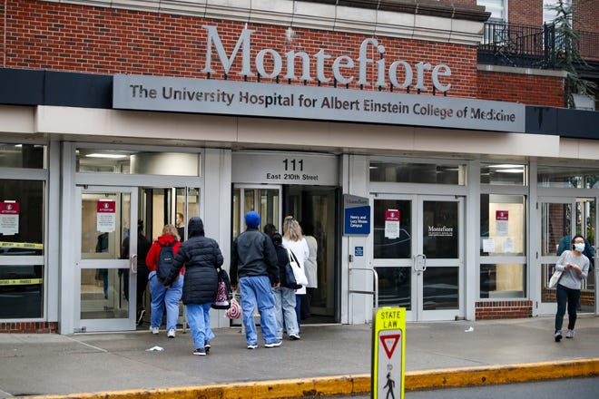 Medical workers enter Montefiore Medical Center during the coronavirus pandemic on April 24, 2020, in the Bronx borough of New York.