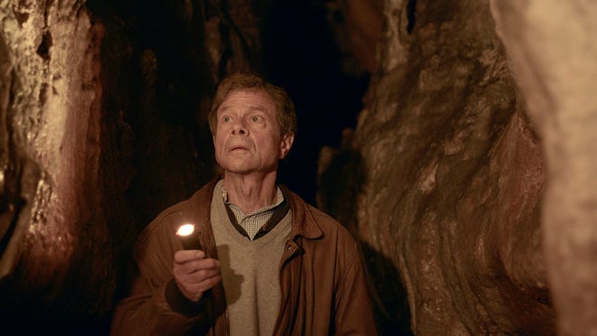 Physicist and author Alan Reitman walks through a prehistoric painted cave in Les Eysies in the Dordorne region of France during the taping of his PBS series. "Search: The quest for meaning in the age of science."