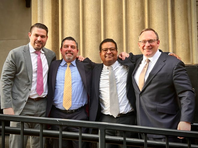 Dr. Lesly Pompy of Monroe, second from right, is pictured with three attorneys from his defense team, from left, Ronald Chapman II, George Donnini and Joe Richotte, at the federal courthouse in Detroit. Pompy was acquitted Jan. 4 of all of the federal drug and health care fraud charges against him.