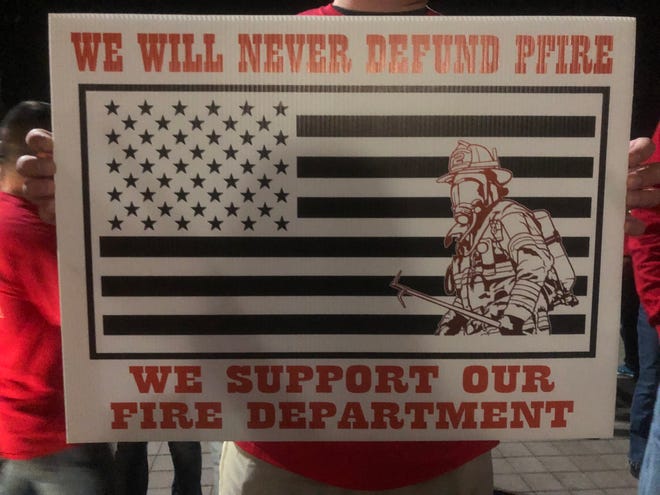 Sign held by members of the Pflugerville Fire Association.