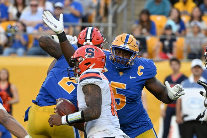 Pittsburgh defensive lineman Deslin Alexandre (5) pressures Syracuse quarterback Carlos Del Rio-Wilson (16) during the second half of an NCAA college football game, Saturday, Nov. 5, 2022, in Pittsburgh, Pa. (AP Photo/Barry Reeger)