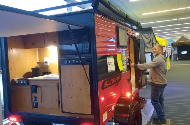 Phil Sorrentino of Glassport checks out all the features that are available in a small camper Tuesday at the Pittsburgh RV Show.