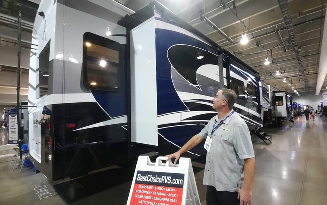 Paul Willis of Best Choice Trailers and RVs in Irwin looks at the high gloss metallic paint on a high-end fifth wheel camper Tuesday at the Pittsburgh RV Show.