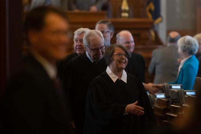 Kansas Supreme Court Chief Justice Marla Luckert is followed by her peers Wednesday following her State of the Judiciary speech in the House Chambers at the Kansas Statehouse.