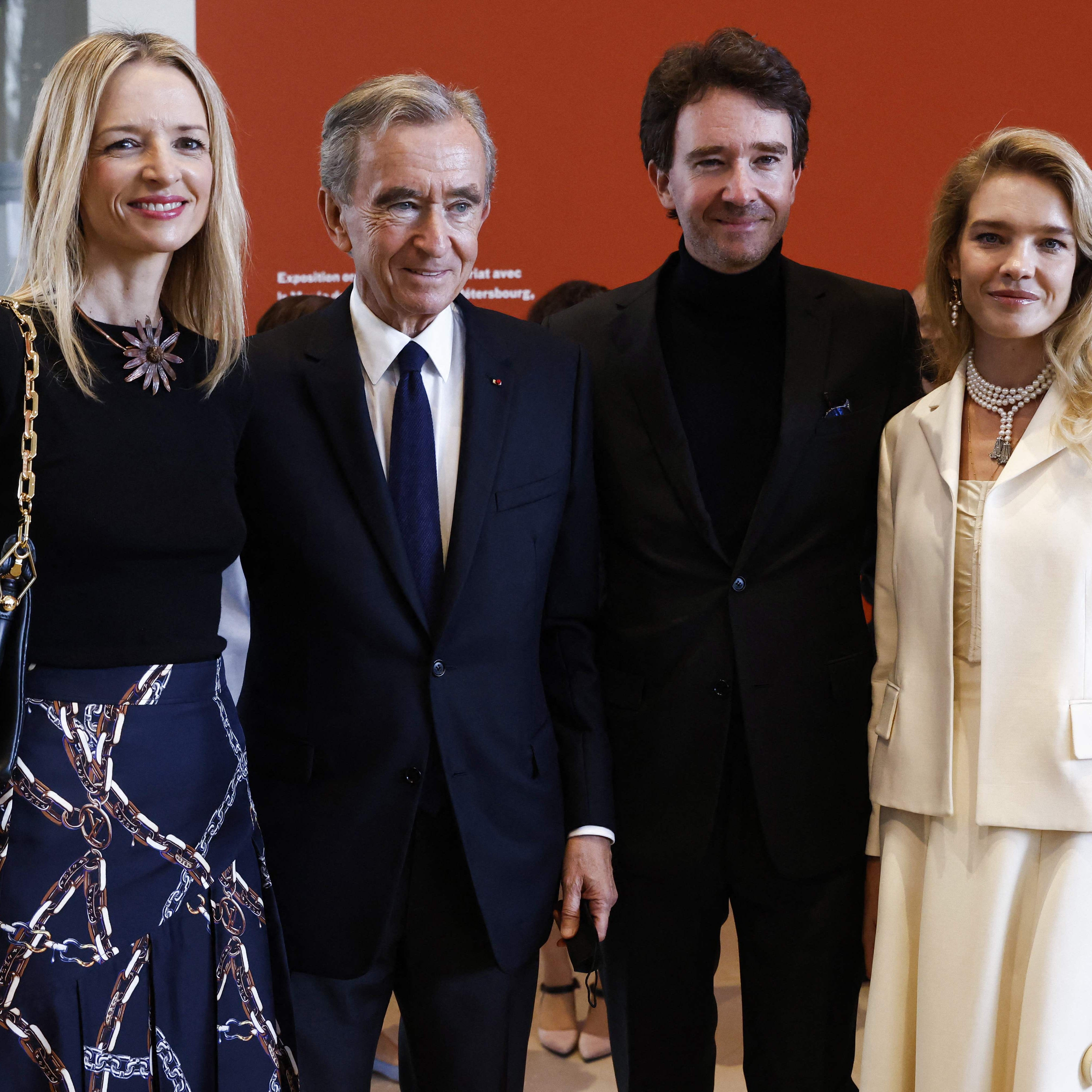This file photo taken on September 21, 2021  shows (From L) Louis Vuitton Executive vice president Delphine Arnault, head of LVMH luxury group, Bernard Arnault, LVMH Communications head Antoine Arnault and his wife Russian model Natalia Vodianova pose during the open of the exhibition of 'The Morozov Collection, Icons of Modern Art' at Fondation Louis Vuitton in Paris.