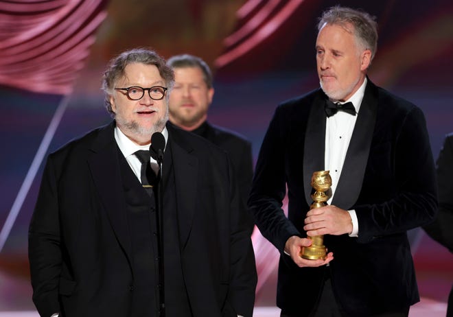 Guillermo del Toro, left, and Mark Gustafson accepting the best animated feature award for "Guillermo del Toro's Pinocchio."