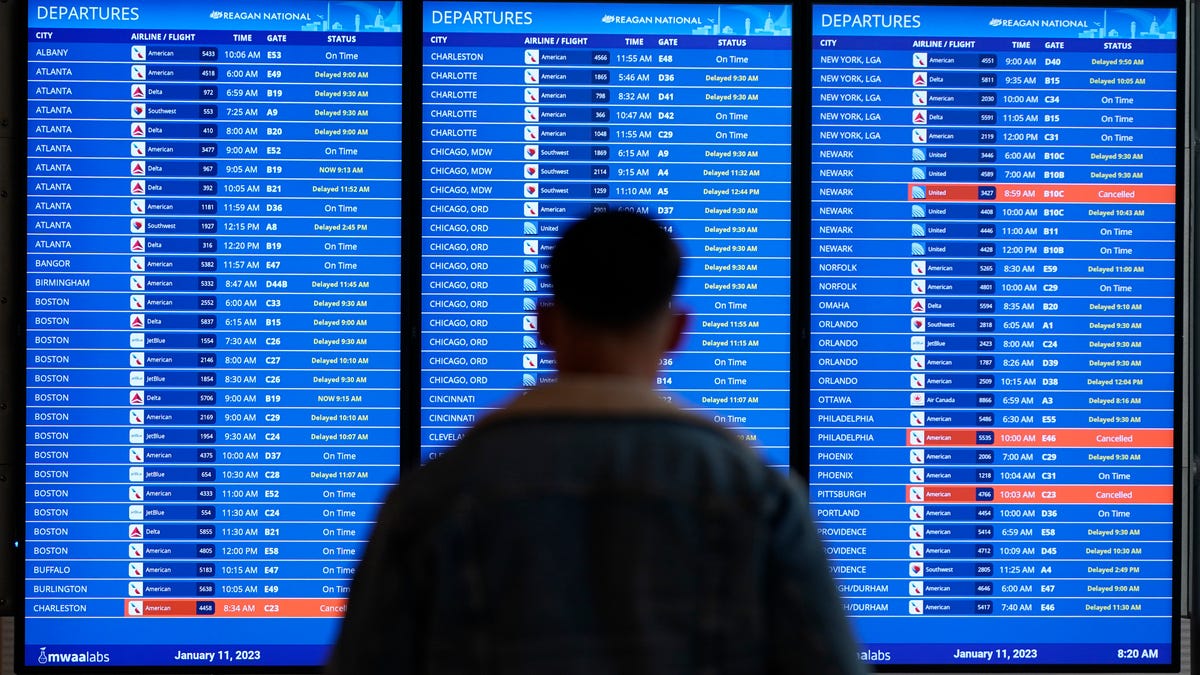 A traveler looks at a flight board with delays and cancellations at Ronald Reagan Washington National Airport in Arlington, Va., Wednesday, Jan. 11, 2023. Thousands of travelers were stranded at U.S. airports due to an hours-long computer outage. If a flight is canceled, experts say most airlines will rebook you on the next available flight. But if you choose to cancel the trip, airlines must provide you with a full refund. (AP Photo/Patrick Semansky) ORG