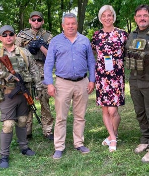 Ashton-Cirillo with Viktor Kovalenko, mayor of Zolochiv, Ukraine, and army members in July 2022.