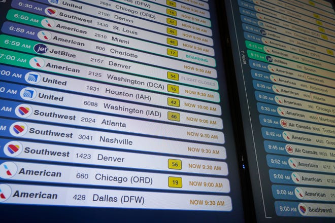 A display shows flights, many delayed, at LaGuardia Airport in New York, Wednesday, Jan. 11, 2023.