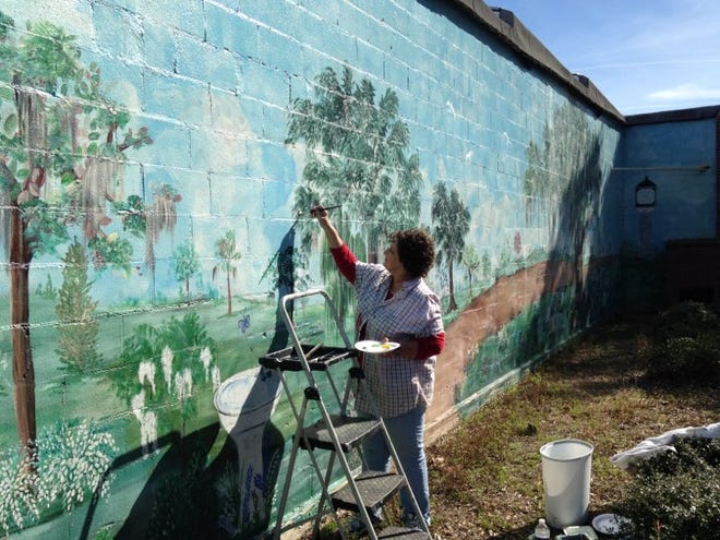 Volunteer artist Joanne Phillips painting the mural at the Exchange Park, Lee Avenue, Hampton.