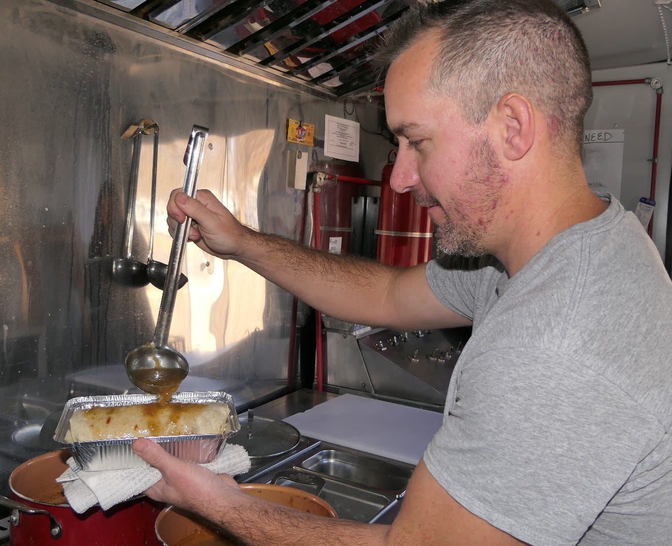 Hutchinson chef cooks up smothered green chili burritos on food truck