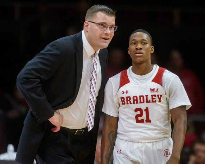 Bradley head coach Brian Wardle, left, has a chat with Duke Deen as the Braves battle Evansville in the second half Wednesday, Jan. 11, 2023 at Carver Arena in Peoria. The Braves defeated the Aces 91-46.