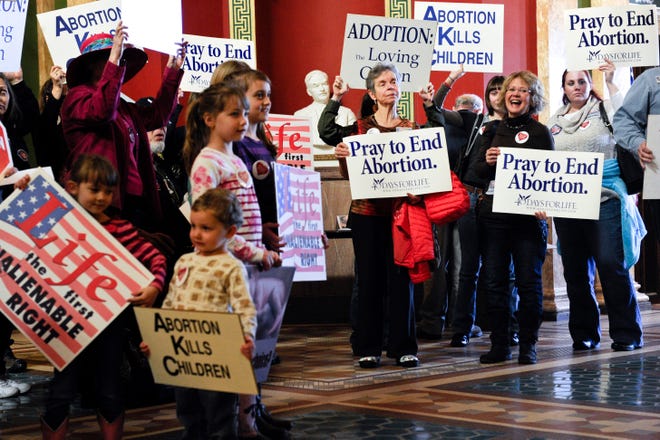 FILE - Protesters fill the Montana state Capitol rotunda in Helena in February 2015 during a rally to show support in an attempt to change the Montana Constitution to define life as beginning at conception. State officials in Republican-controlled Montana want to require prior authorization before its health department pays for abortions for people covered by Medicaid, a proposal critics say would reduce access and delay or even prevent abortion care for low-income women in a state. (Thom Bridge/Independent Record via AP, File)